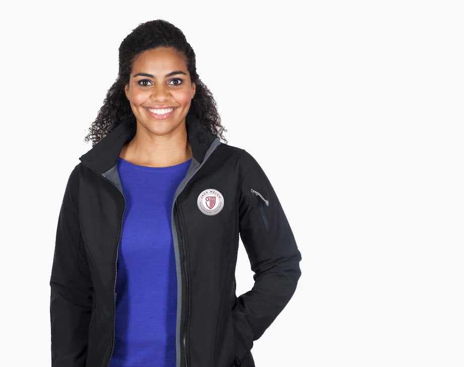Woman wearing a black JWMI soft shell jacket